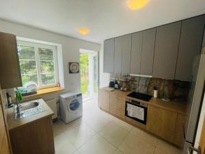 a kitchen with a sink and a washing machine at Luxury Apartments in Wrocław