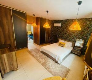 a bedroom with a bed and some lights at Luxury Apartments in Wrocław