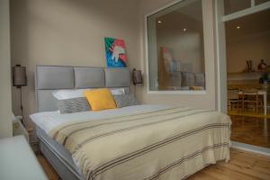 a bedroom with a large bed with yellow pillows at Dzeltenais Dāvids in Liepāja