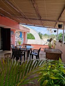 a patio with a table and chairs and a mural at Cozy Cabana - Maynard Palace in Benaulim +42 photos