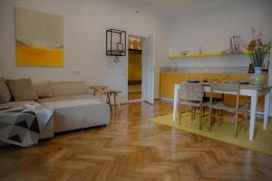 a living room with a couch and a table at Dzeltenais Dāvids in Liepāja
