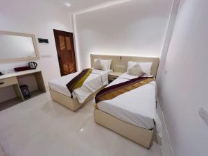 Voodi või voodid majutusasutuse Vilu Himmafushi toas