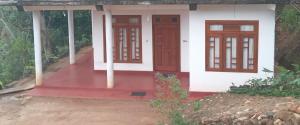 a small house with two doors and a porch at Freedom Lodge in Ella