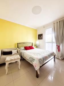 a bedroom with a bed and a couch and a window at Cop30 in Belém