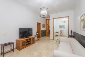 a living room with a couch and a tv at The Red House - 3BR with Private Terrace in Guanarteme