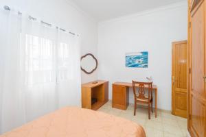 a bedroom with a desk and a bed and a chair at The Red House - 3BR with Private Terrace in Guanarteme