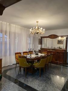 a dining room with a table and chairs and a chandelier at Villa En Mijas Con Vistas Al Mar in Mijas