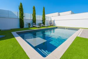 a swimming pool in the yard of a house at Villa Mauricio with jacuzzi and private swimming pool in Santa Barbara