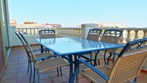 a blue table and chairs on a balcony at Canela Park by Ĥ - Playa Isla Canela ICHP34P3 in Isla Canela