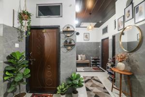 a hallway with a wooden door and a living room at FabExpress Milan Palace in Ayodhya