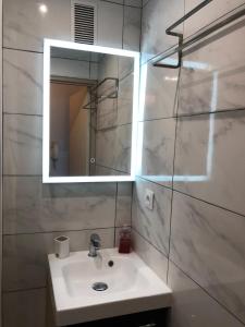 a bathroom with a sink and a mirror at La petite Marseillaise in Marseille