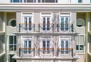 a building with balconies on the side of it at The Passport Hotel in Assagao