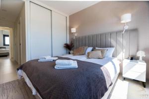 a bedroom with a large bed with towels on it at Higuericas Views in El Mojón +14 photos