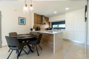 a kitchen with a table and chairs and a sink at Higuericas Views in El Mojón