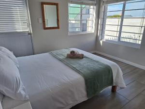 a bedroom with a bed with a towel on it at Ondermaat in Agulhas