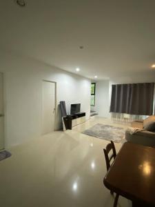 a living room with a couch and a table at Town House in Ban Ket Ho