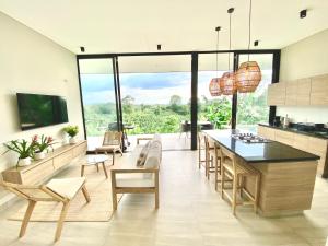 a kitchen with a table and chairs and a large window at Casa MOARA in Pereira