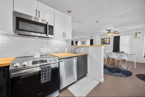 a kitchen with a stove and a microwave at Stunning Lake Travis Retreat in Austin in Buffalo Gap
