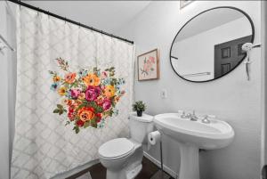 a bathroom with a toilet and a sink and a mirror at Stunning Lake Travis Retreat in Austin in Buffalo Gap