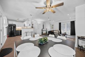 a living room with a dining table and a ceiling fan at Stunning Lake Travis Retreat in Austin in Buffalo Gap +24 photos