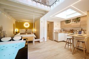 a bathroom and a bedroom with a tub in a room at Suite Magnolia in Évreux