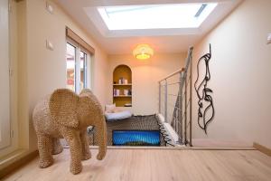 a room with an elephant in a room with a bed at Suite Magnolia in Évreux +16 photos