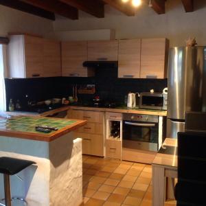 a kitchen with stainless steel appliances and a counter at CARDABELLE maison authentique à louer in Millau
