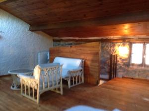 a room with two chairs and a table and a window at CARDABELLE maison authentique à louer in Millau
