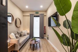 a living room with a couch and a table at Waou Essence II Lavapiés - Alquiler Corta Duración in Madrid