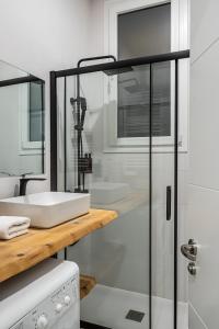 a white bathroom with a sink and a shower at Waou Essence II Lavapiés - Alquiler Corta Duración in Madrid