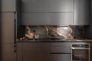 a kitchen with stainless steel cabinets and a sink at Waou Plaza de España IV - Alquiler Corta Duración in Madrid +21 photos