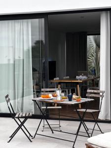 a table and two chairs on a balcony with food on it at Duna Colorada in Lajares