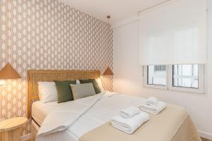 a bedroom with a large bed with towels on it at Waou Best IV Madrid Rio in Madrid