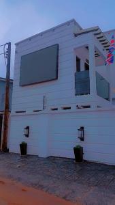 a white building with a door and a window at DD APARTMENT And LOUNGE in Benin City +2 photos