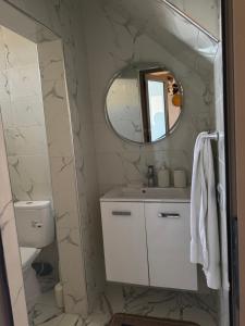 a bathroom with a sink and a mirror at Rooftop apartments in Taghazout