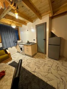 a kitchen with a refrigerator and a stove top oven at Rooftop apartments in Taghazout