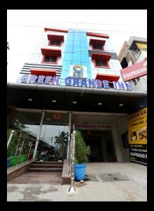 a building with a sign on the front of it at Green Grande Inn in Chennai