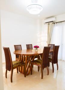 a dining room table and chairs with a wooden table at EMY guest HOUSE in Kofa