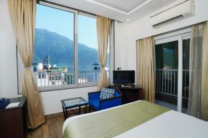 Ένα ή περισσότερα κρεβάτια σε δωμάτιο στο N3N Ganga Retreat by Stotrak +99 φωτογραφίες