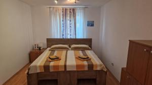 a bedroom with a bed with two towels on it at Simple 3-room apartment in Kukuljanovo