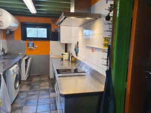 a kitchen with a sink and a counter top at Vakantie verblijf in Bredene +10 photos