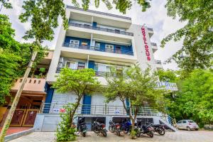 a building with motorcycles parked in front of it at HOTEL OXUS, Pratap Nagar in Jaipur