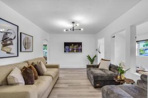 a living room with a couch and a tv at Luxury Miami Home Next to Wynwood & Downtown in Miami