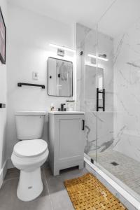 a white bathroom with a toilet and a shower at Luxury Miami Home Next to Wynwood & Downtown in Miami