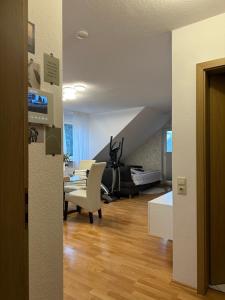 a living room with a table and chairs and a staircase at Weitblick Neviges in Velbert