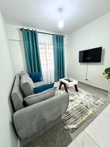 TV a/nebo společenská místnost v ubytování Queens Stay Apartment