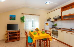 a kitchen with a table with a yellow table cloth at Apartman Ana by Villas Guide in Ika +11 photos