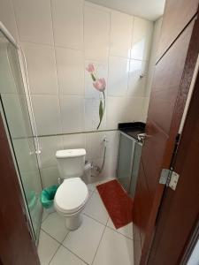a small bathroom with a toilet and a shower at Apartamento COP 30, Belém in Belém