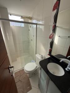 a bathroom with a shower and a toilet and a sink at Apartamento COP 30, Belém in Belém +13 photos