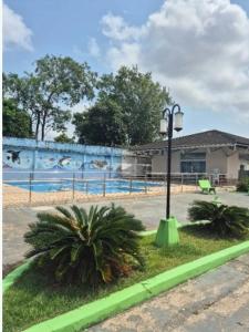 a street light next to a fence with a mural at Apartamento COP 30, Belém in Belém